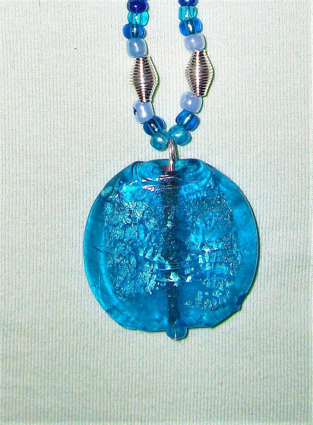 Blue necklace with large blue pendant.