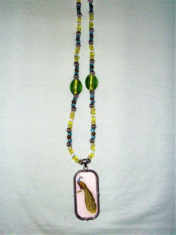 Green, blue, and brown necklace with a peacock pendant.